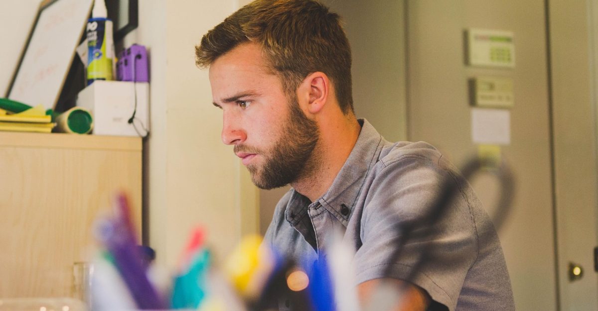 Man, work, desk — Mastering MetaTrader 4: A Comprehensive Guide for Beginner